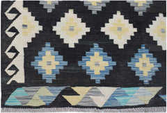 Handwoven Afghan Maimana kilim featuring a black background with geometric diamond patterns.