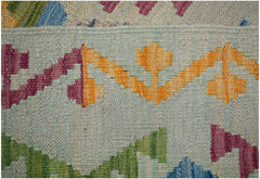 A close-up of a handmade Afghan Maimana kilim featuring geometric patterns in vibrant wool colors.