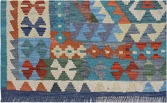 Handwoven Afghan Maimana kilim rug featuring a colorful geometric pattern and fringed edges.