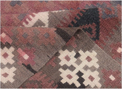 A handmade Afghan Maimana kilim rug featuring geometric patterns in shades of brown, red, and cream.