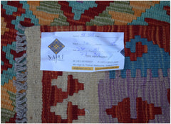 A handmade Afghan Maimana kilim featuring a vibrant geometric pattern in wool.