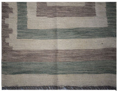 Handwoven Afghan Maimana kilim rug featuring a geometric pattern in muted green and brown tones.