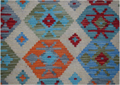Handwoven Afghan Maimana kilim rug featuring a geometric pattern in vibrant blue, orange, and red.
