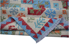 Handwoven Afghan Maimana kilim rug featuring a geometric pattern in red, blue, green, and orange.