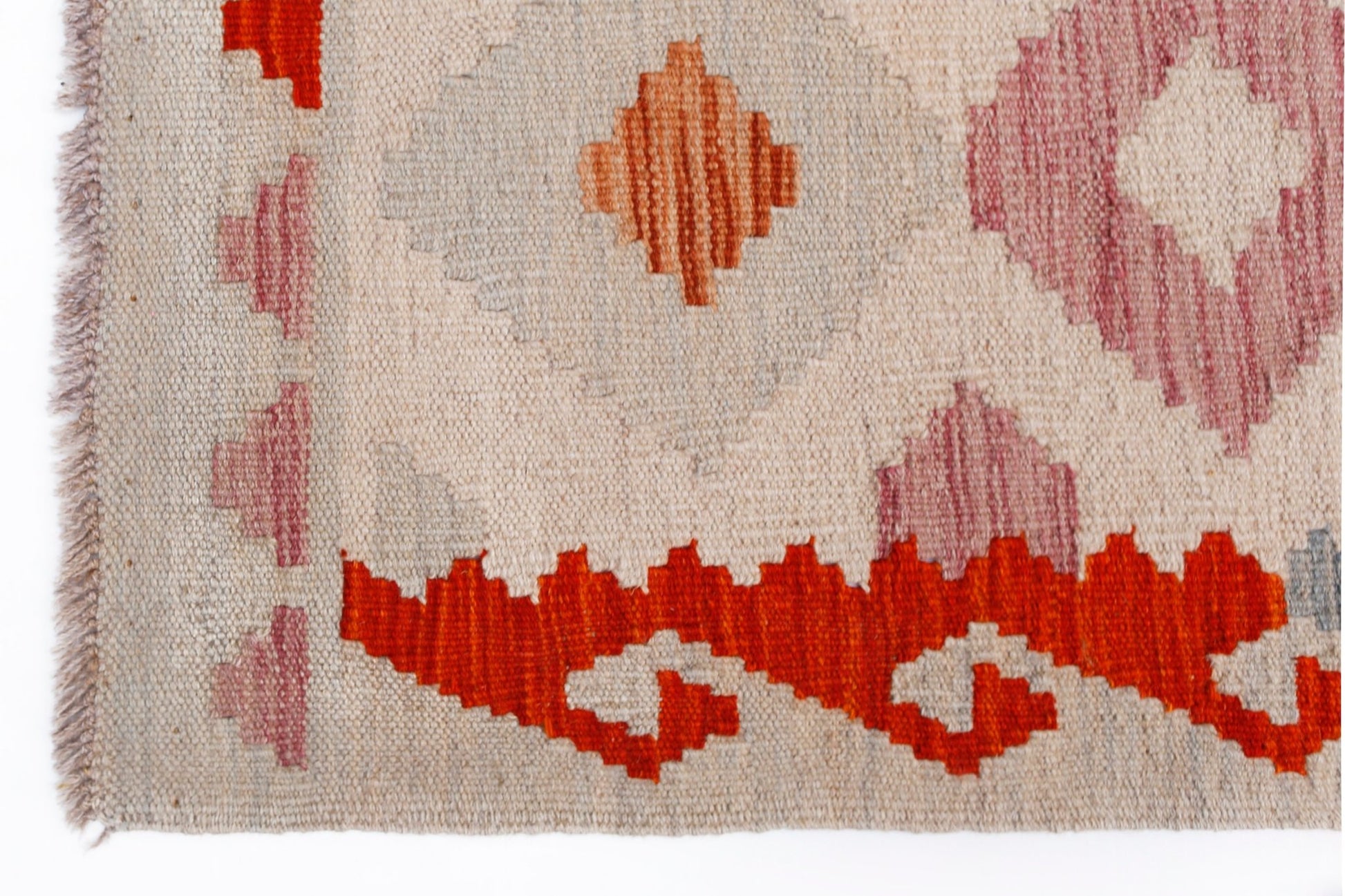 Handwoven Afghan Maimana kilim rug featuring geometric patterns in orange, pink, and cream tones.