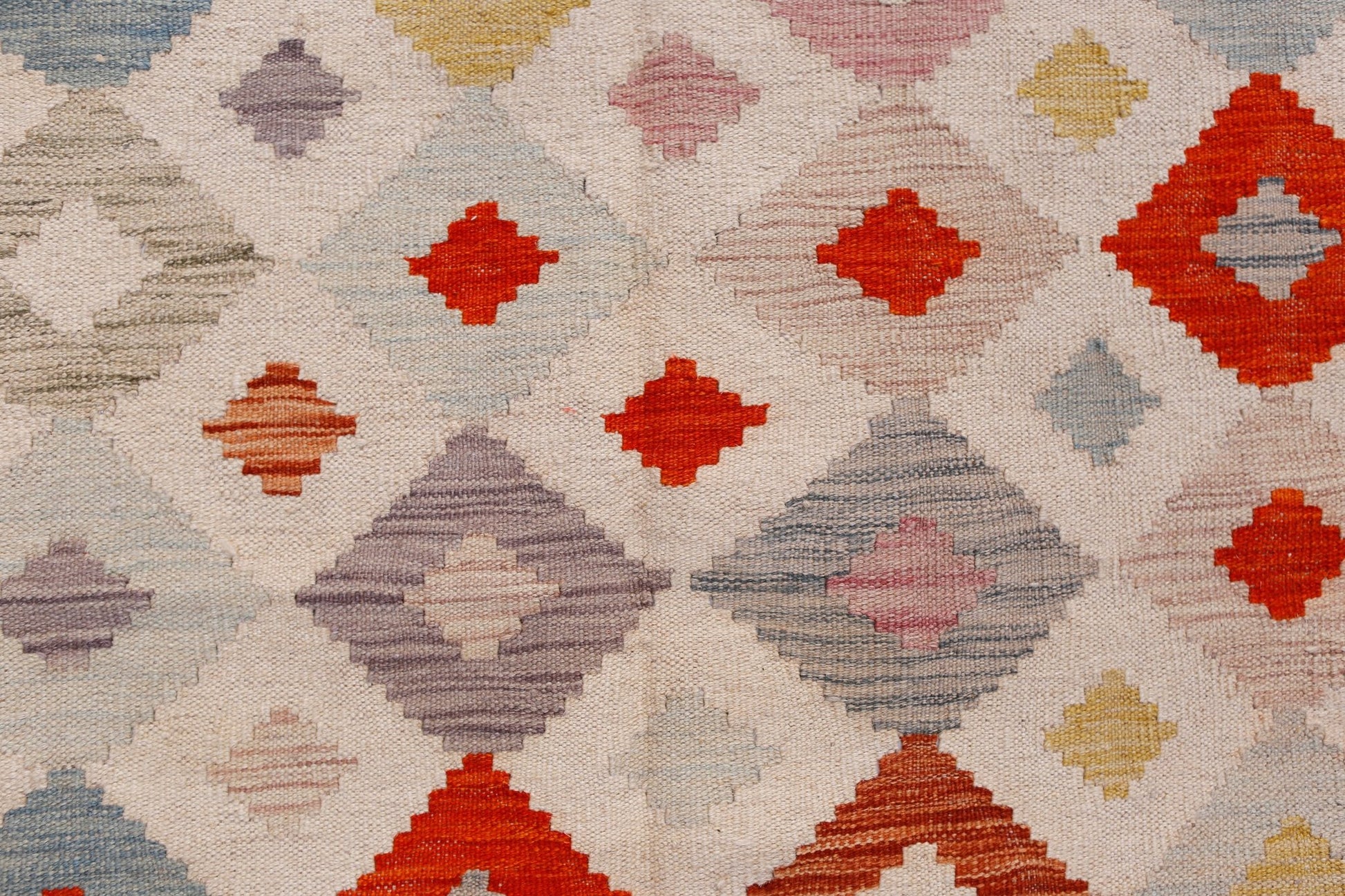 Handwoven Afghan Maimana kilim featuring a geometric diamond pattern in vibrant multicolored wool.