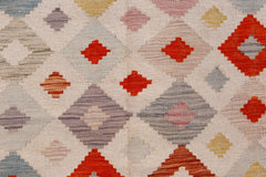Handwoven Afghan Maimana kilim featuring a geometric diamond pattern in vibrant multicolored wool.
