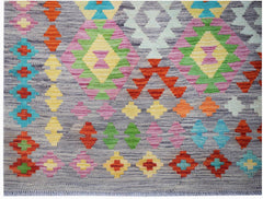 Afghan Maimana Kilim with geometric diamond patterns in multiple colors on a gray background.
