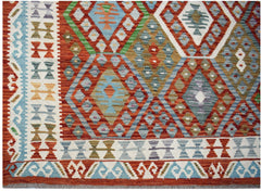 Handwoven Afghan Maimana kilim featuring a geometric diamond pattern in vibrant multi-colored wool.
