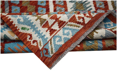 A handwoven Afghan Maimana kilim rug featuring geometric patterns in red, blue, and cream wool.