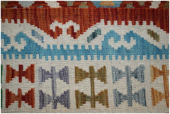 A close-up of a handmade Afghan Maimana kilim featuring geometric patterns in vibrant colors.