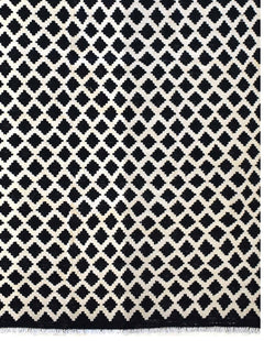 Handmade Afghan Maimana kilim rug featuring a repeating black and white geometric pattern.
