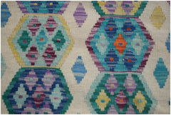 Handwoven Afghan Maimana kilim featuring a colorful geometric pattern on a cream background.