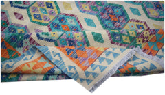 A handmade Afghan Maimana kilim rug featuring a colorful geometric pattern on a cream background.