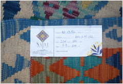 A handmade Afghan Maimana Kilim rug featuring a geometric pattern in blue, orange, and cream.
