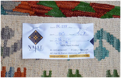A handmade Afghan Maimana kilim featuring a flatweave texture and colorful geometric patterns.