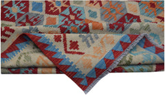 A handmade Afghan Maimana kilim rug featuring a colorful geometric pattern on a cream background.