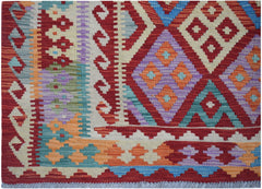 Handwoven Afghan Maimana kilim featuring a vibrant geometric pattern in wool.