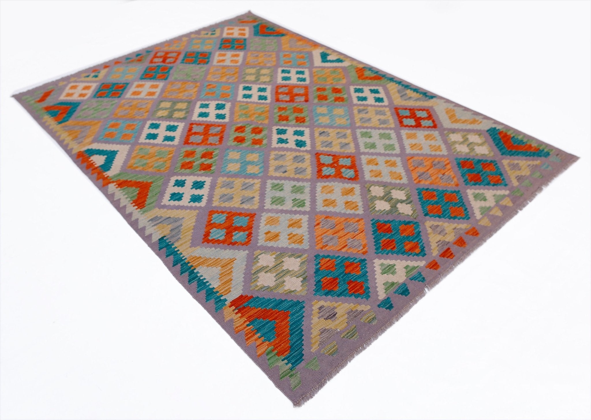 Handwoven Afghan Maimana kilim rug featuring a colorful geometric pattern on a purple background.