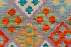 Handwoven Afghan Maimana kilim rug featuring a geometric diamond pattern in vibrant colors.