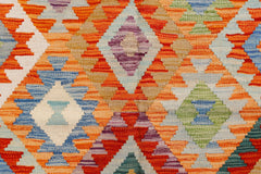 Handwoven Afghan Maimana kilim featuring a vibrant geometric diamond pattern in wool.