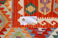 A handwoven Afghan Maimana kilim featuring a vibrant geometric pattern in orange, purple, and blue.