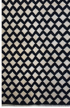 Handmade Afghan Maimana kilim rug featuring a repeating black and cream geometric pattern.