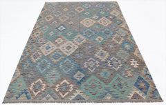 Handwoven Afghan Maimana kilim rug featuring a geometric diamond pattern in blue and beige tones.