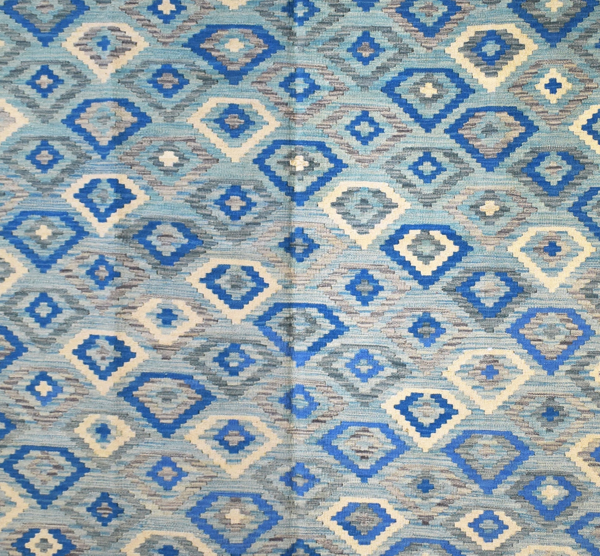 Handmade Afghan Maimana kilim rug featuring a repeating geometric diamond pattern in shades of blue.