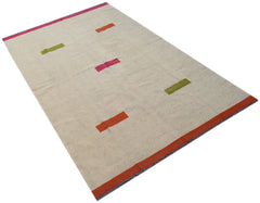 Handwoven Afghan Maimana kilim rug with a cream base and colorful geometric accents.