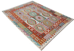 Handwoven Afghan Maimana kilim rug featuring a colorful geometric pattern in wool.