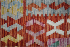A close-up of a handmade Afghan Maimana kilim featuring geometric patterns in vibrant colors.