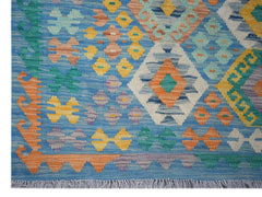 Handwoven Afghan Maimana kilim rug featuring a blue background with colorful geometric patterns.