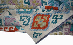 Handwoven Afghan Maimana kilim rug featuring a geometric pattern in vibrant multicolored wool.