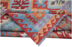 A handmade Afghan Maimana kilim rug featuring vibrant geometric patterns in wool.