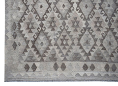 Handwoven Afghan Maiamana kilim rug featuring a grey geometric diamond pattern in natural wool.