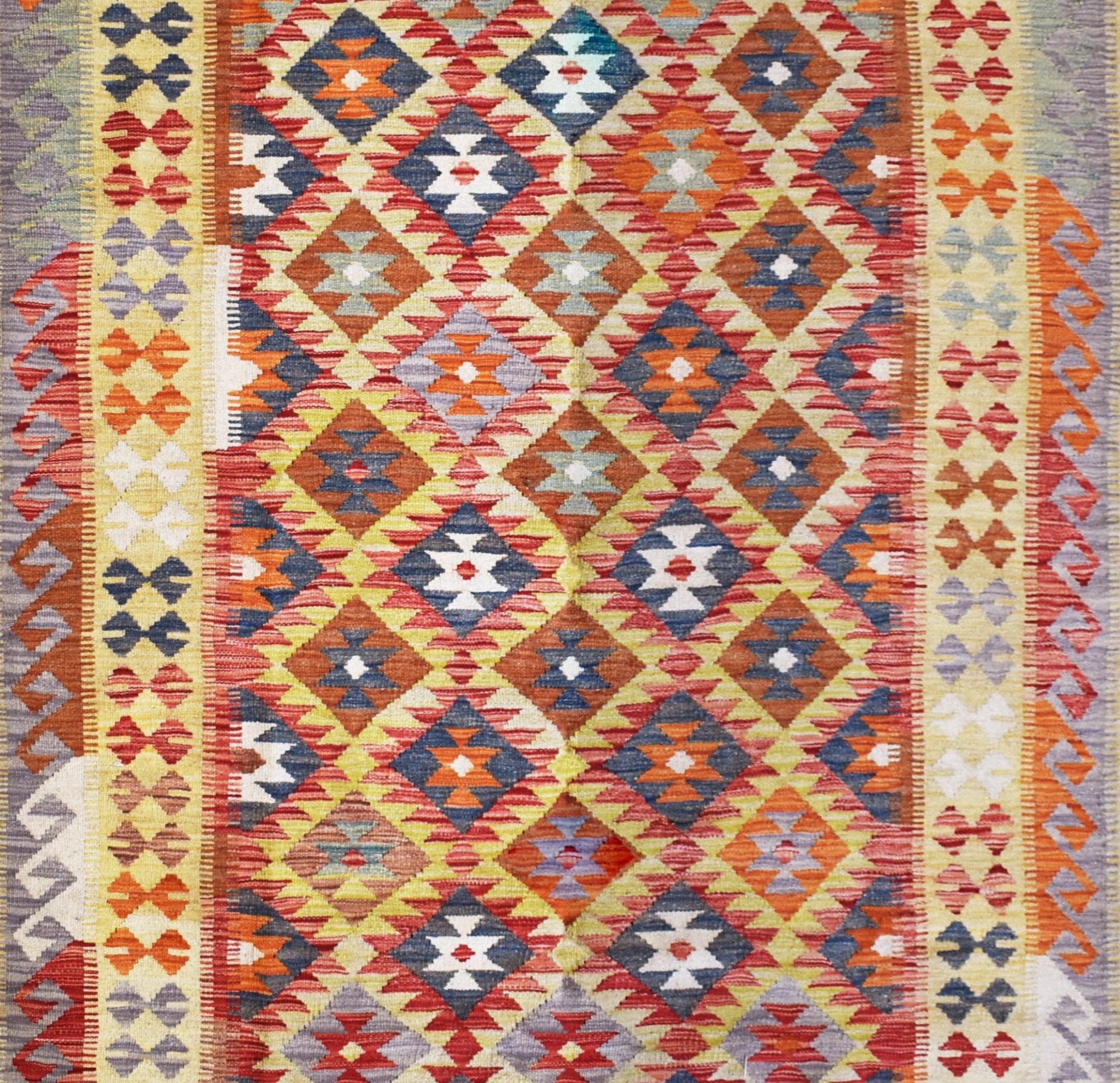 Handmade Afghan Maimana kilim rug featuring a vibrant geometric diamond pattern in wool.