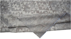 A handwoven Afghan Maiamana kilim rug featuring a grey and white geometric pattern.