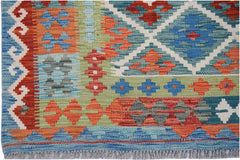 Handwoven Afghan Maimana kilim rug featuring a geometric pattern in vibrant blue, red, and green.