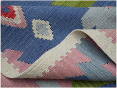 A handwoven Afghan Maimana kilim rug featuring a geometric pattern in blue, pink, and green.