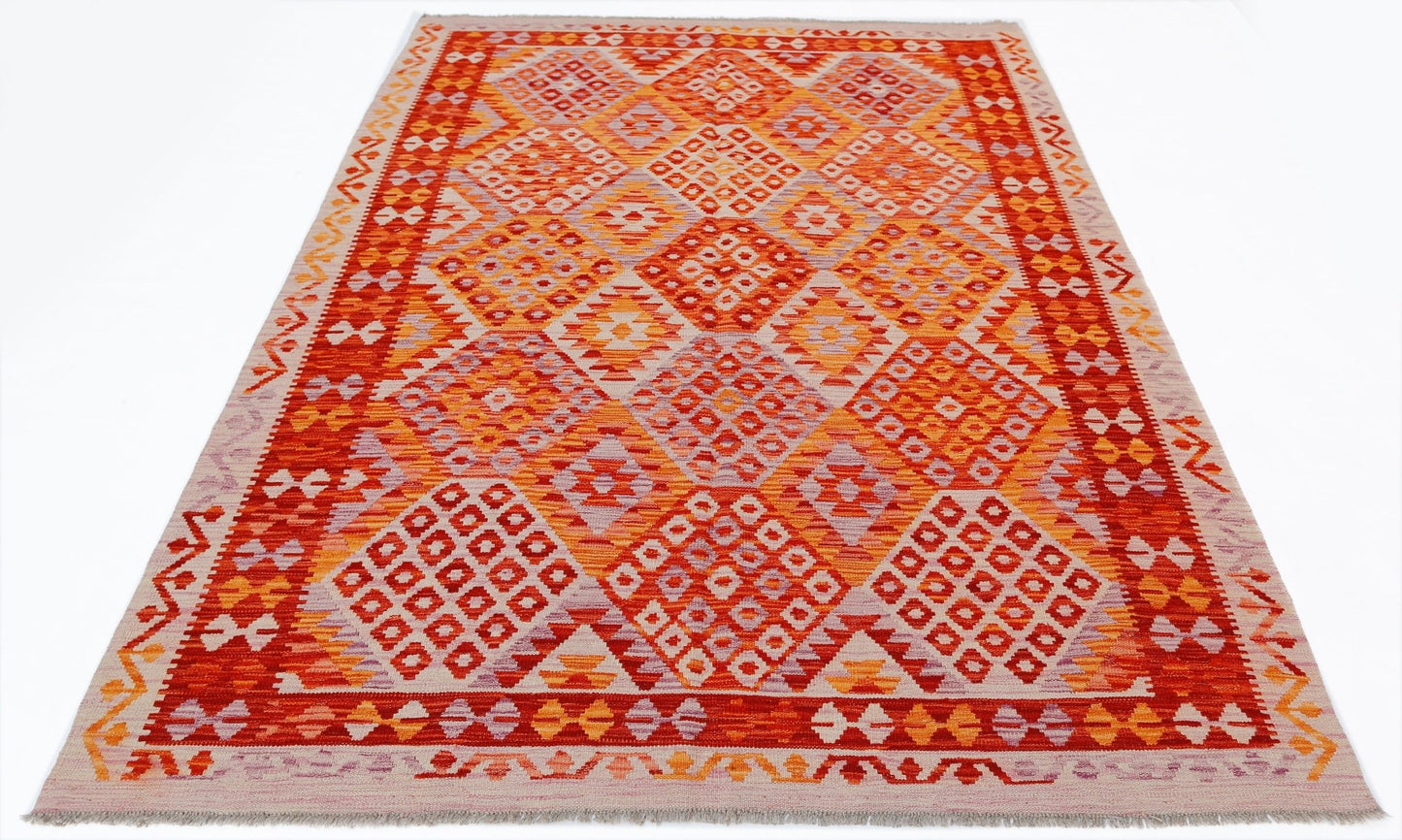 Handwoven Afghan Maimana kilim rug featuring a vibrant geometric diamond pattern in warm tones.