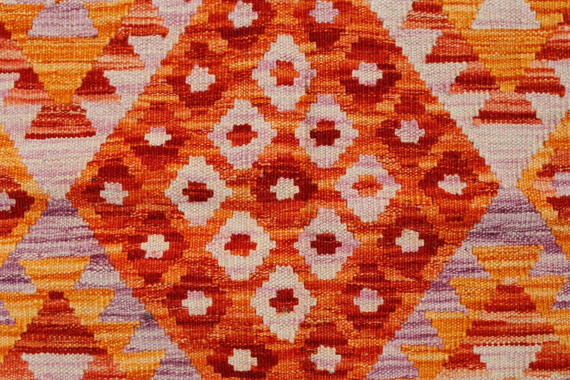 Handwoven Afghan Maimana kilim featuring a vibrant geometric diamond pattern in orange and red.