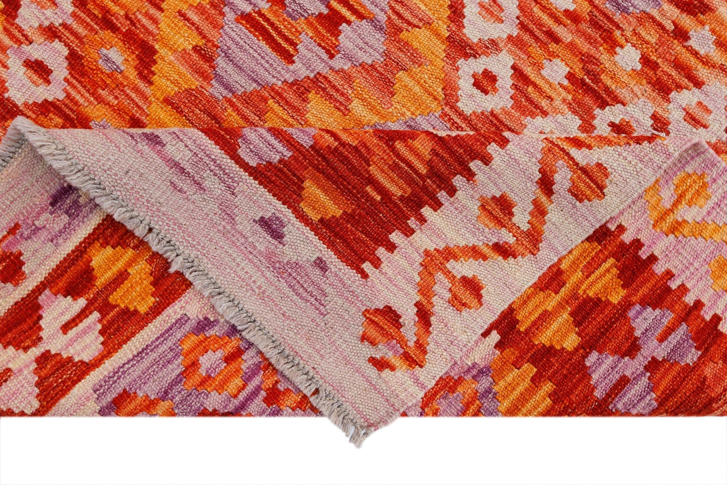 A handwoven Afghan Maimana kilim rug featuring a geometric pattern in vibrant orange and purple.