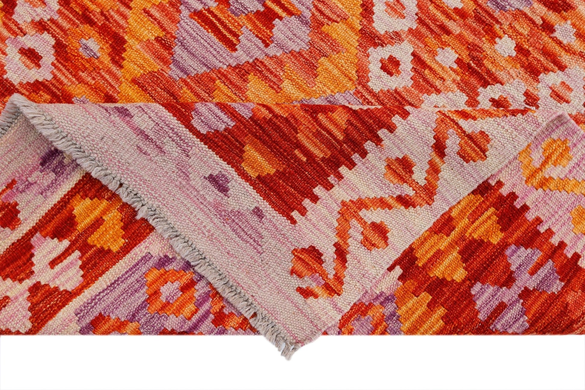 A handwoven Afghan Maimana kilim rug featuring a geometric pattern in vibrant orange and purple.