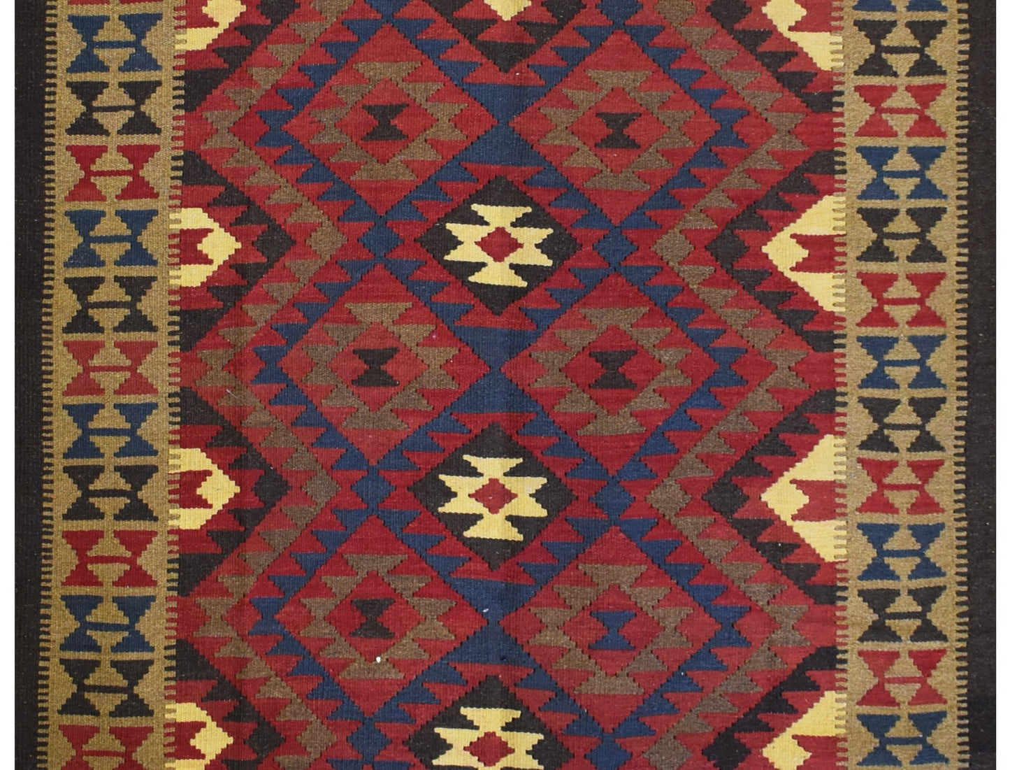 Handmade Afghan Maimana kilim rug featuring a geometric diamond pattern in red, blue, and tan.