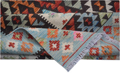 A handmade Afghan Maimana kilim rug featuring geometric patterns in vibrant red, blue, and orange.