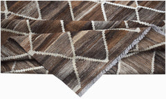 A handmade Afghan Maimana kilim rug featuring a brown and white geometric diamond pattern.