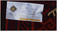 A handwoven Afghan Maimana kilim featuring a geometric pattern in rich red and dark tones.