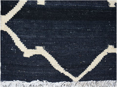 Handwoven Afghan Maimana kilim rug featuring a geometric cream pattern on a dark blue background.