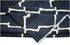 A handmade Afghan Maimana kilim rug featuring a dark blue and white geometric pattern.